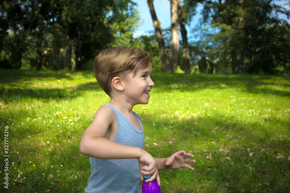 Happy boy during spring day at the park. Happy boy during spring day at the park.