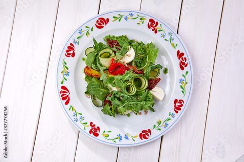 zucchini rolls with fresh salad photo