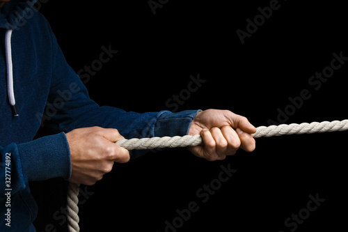 hands with a rope on a black background