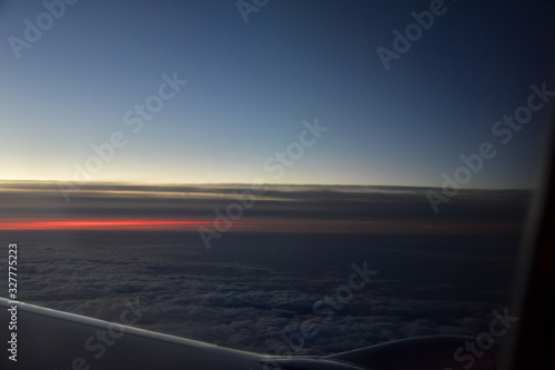 mysterious sunset with clouds from the airplane window with