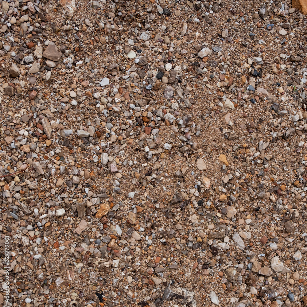 Tecture of a sand with little seashore rocks. Top view with copy space Tecture of a sand with little seashore rocks. Top view with copy space