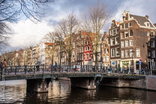 Amsterdam city center with traditional beautiful old houses, bridge and canal