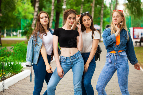 Four schoolgirls in summer park