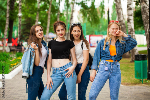 Four schoolgirls in summer park