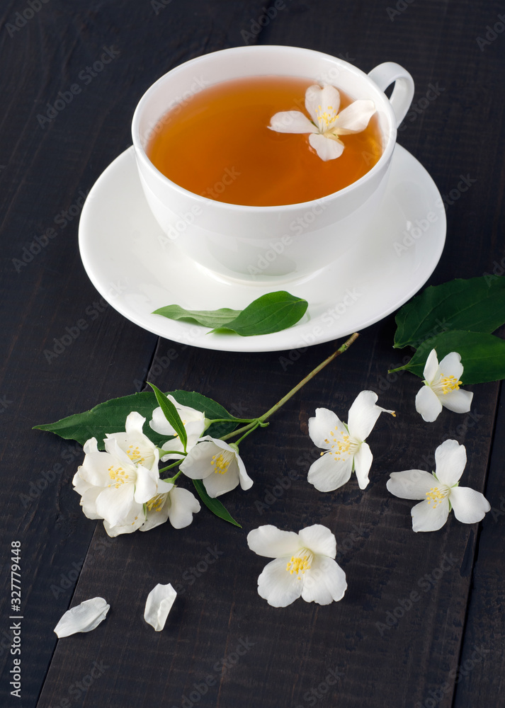 Jasmine flowers and cup of fragrant tea Jasmine flowers and cup of fragrant tea