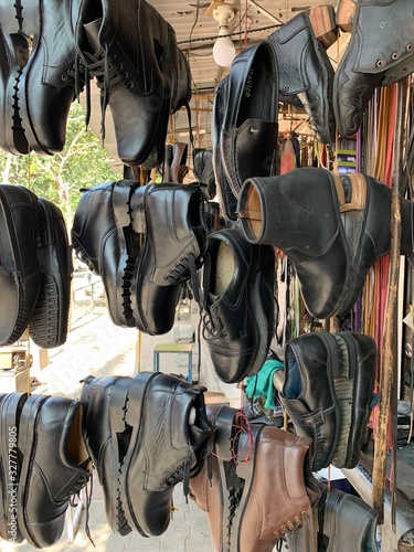 Black Shoes Hanging outside the shop of an Indian Shoemaker.