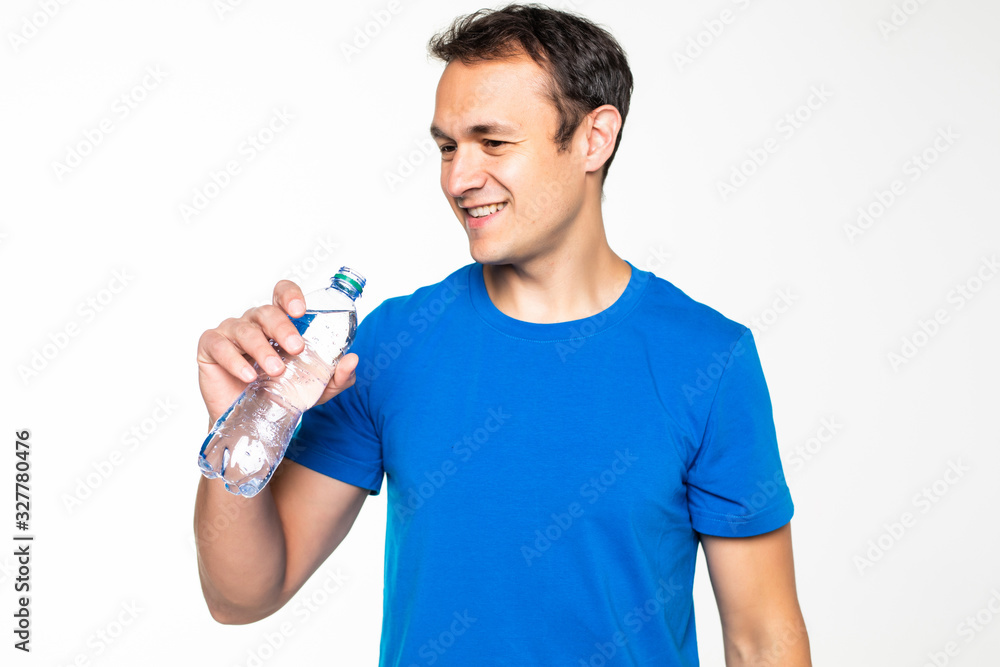 Fit man drinking water with towel on his shoulders isolated on white background