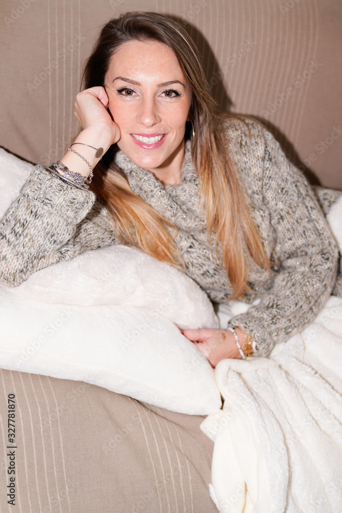 Happy woman relaxing on comfortable soft sofa enjoying lifestyle home on couch smiling Happy woman relaxing on comfortable soft sofa enjoying lifestyle home on couch smiling