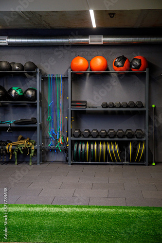 Close up of many metal dumbbells on rack in sport fitness gym center. Weight Training. Sport and fitness equipment and accessories.