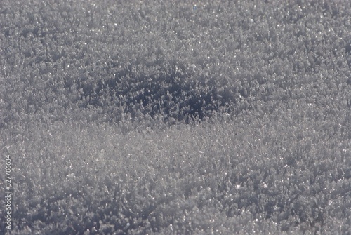 deepening in Close up ice carpet from sparkling and flaring sharp large crystals of snow