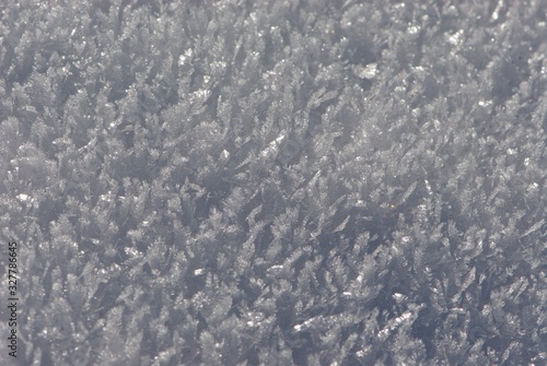 Close up ice carpet from sparkling and flaring sharp large crystals of snow