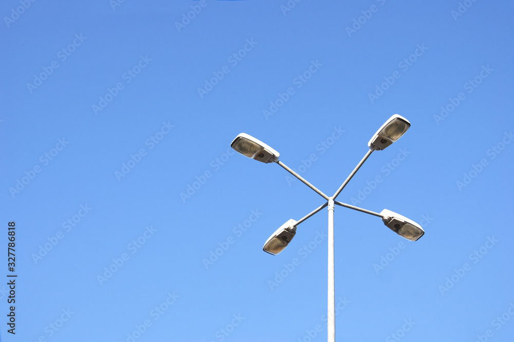 Street lamps with economical lamps with on a background of cloudless sky. Street lamps with economical lamps with on a background of cloudless sky.