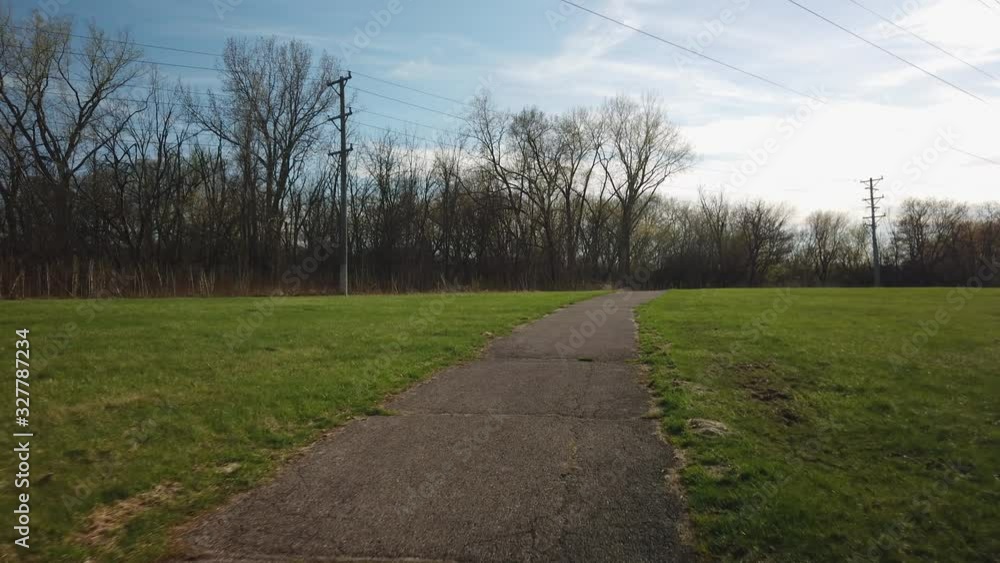 Slow walk down a bike path in the middle of the day, wide shot Slow walk down a bike path in the middle of the day, wide shot