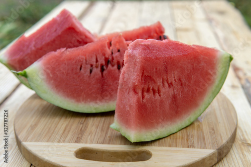 Fresh ripe sliced watermelon on wooden rustic background