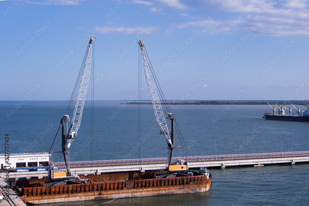 2 units of Harbor Mobile Crane (HMC) are being loaded onto barges