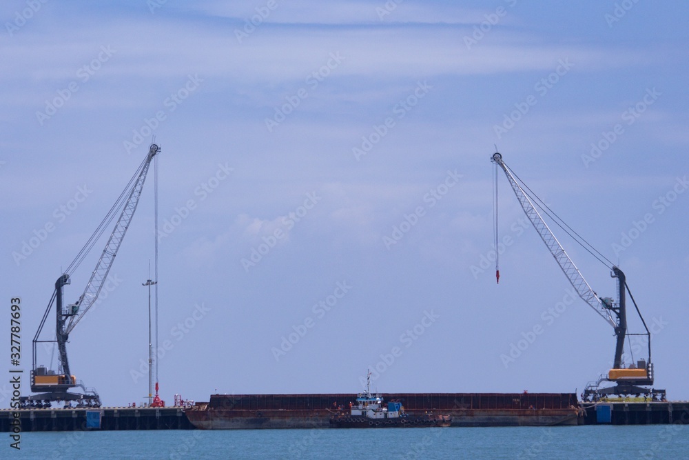 2 units of Harbor Mobile Crane (HMC) are being loaded onto barges