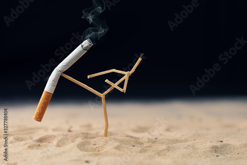 quit smoking concept - match man kick off a cigarette photo