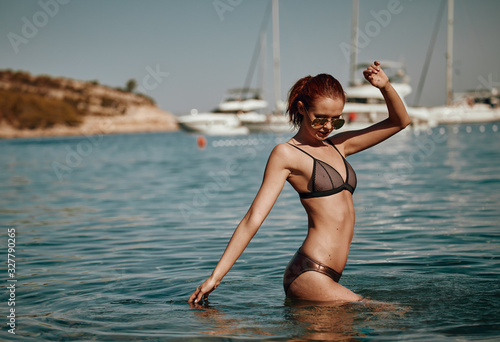 Bikini girl on the beach. Young beautiful woman in bikini on the beach on Adriatic Sea