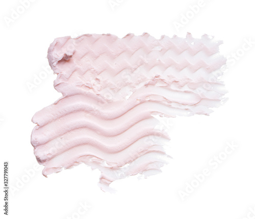 Gently pink brush strokes and texture of face cream or pink acrylic paint on a white background