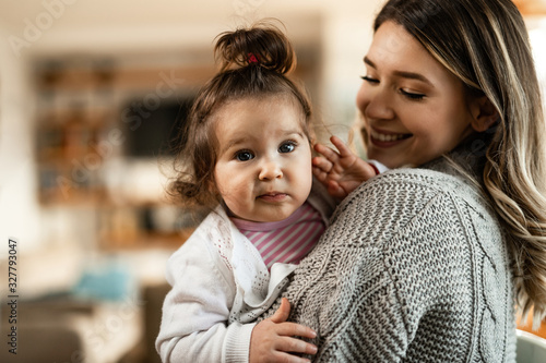 Happy mother spending a day with her small daughter at home.