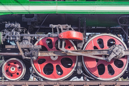 Wheels of the retro steam train standing by the platform.