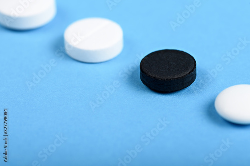 white and black tablets on blue background