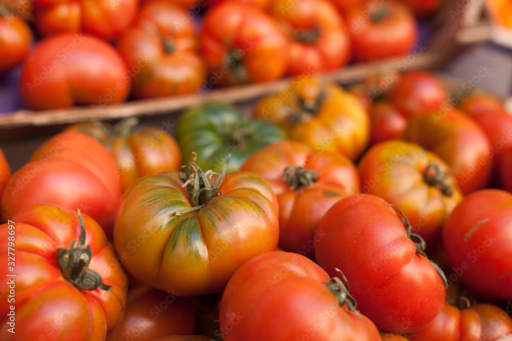 fresh tomatoes on branch in wicker baskets on counter fresh tomatoes on branch in wicker baskets on counter