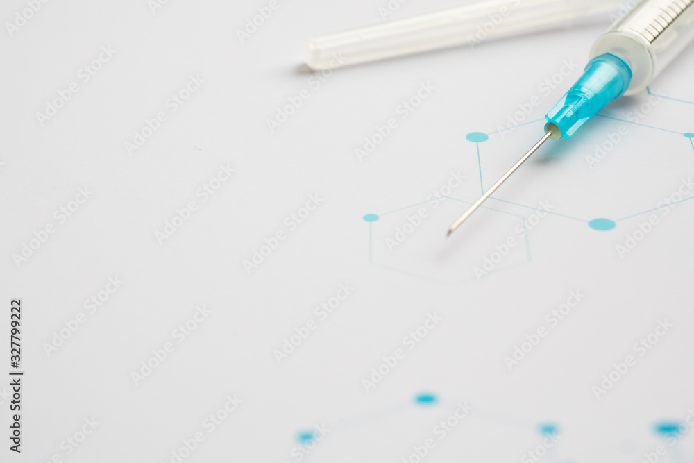 Medical syringe on the science background Medical syringe on the science background