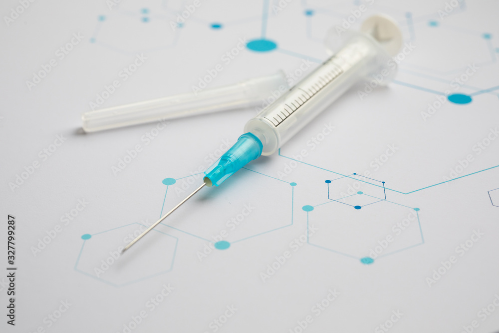 Medical syringe on the science background Medical syringe on the science background