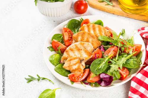 Salad with Grilled chicken, green leaves and vegetables.