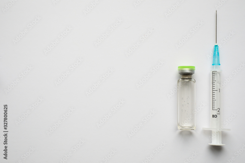 Medical ampoules and syringe on the science background Medical ampoules and syringe on the science background