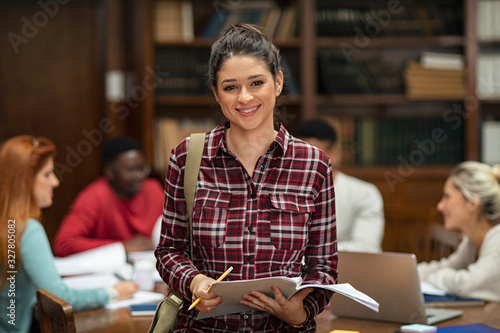 Smiling student girl in library