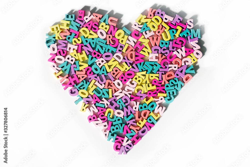 Plenty of colorful wooden letters on a White background shaped in a Heart Form