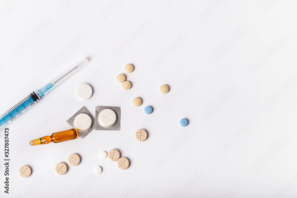 Medicaments on a white background. Syringe, pills, injection and other drugs to cure people and support health. Medicines and tablets against diseases and viruses. Medicaments on a white background. Syringe, pills, injection and other drugs to cure people and support health. Medicines and tablets against diseases and viruses.