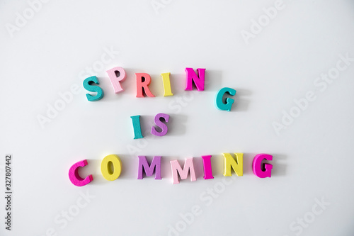Spring is Comming written by colorful wooden letters
