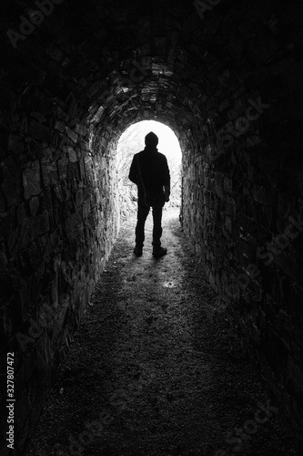 Silhouette of a man in a tunnel in black and white 