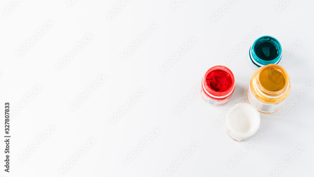creativity concept, paint jars on a white background with free space for text