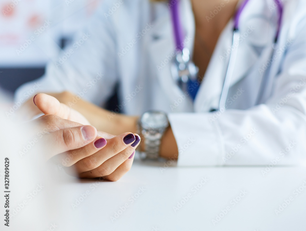 Woman doctor helping senior holding hand in hospital Woman doctor helping senior holding hand in hospital