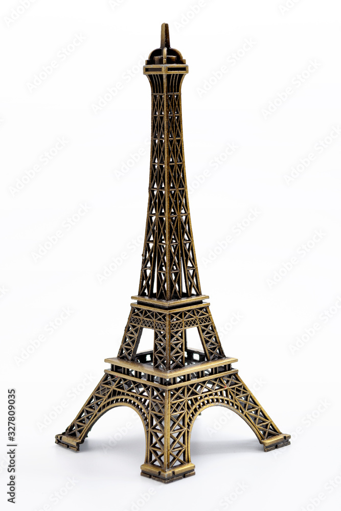 European landmarks, travelling to Paris and parisian ornament concept with miniature metallic eiffel tower isolated on white background with clipping path cutout