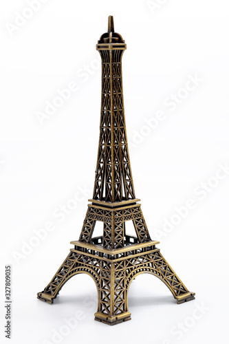 European landmarks, travelling to Paris and parisian ornament concept with miniature metallic eiffel tower isolated on white background with clipping path cutout