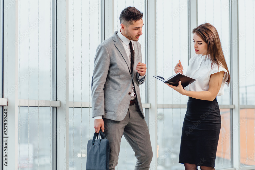 Secretary writes down tasks of mature chief, who is going on a business trip. Secretary writes down tasks of mature chief, who is going on a business trip.