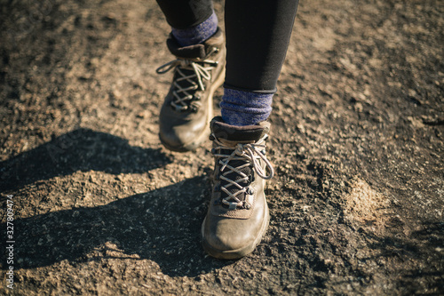 Woman's hiking boots on rocky path