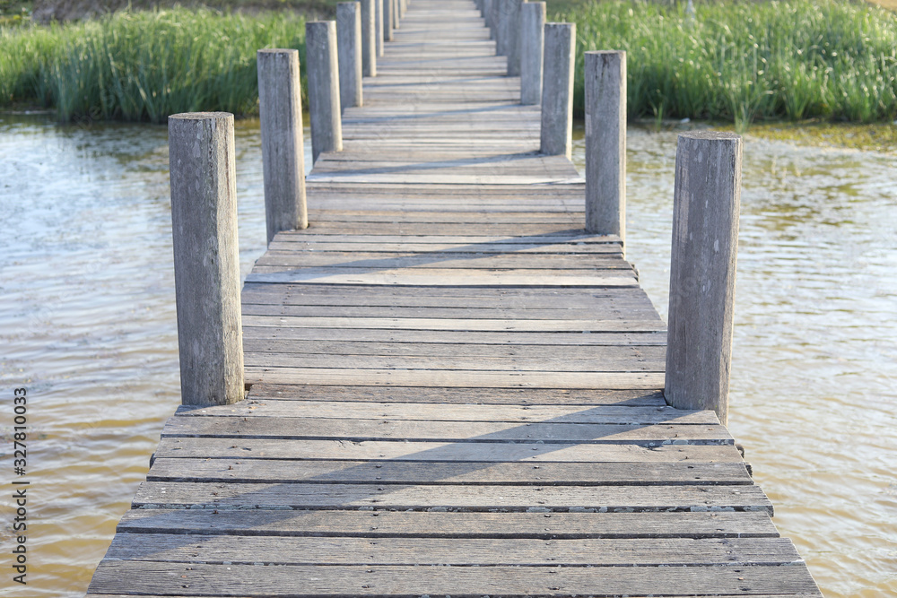 Fototapeta premium Grey old wooden bridge with lake 