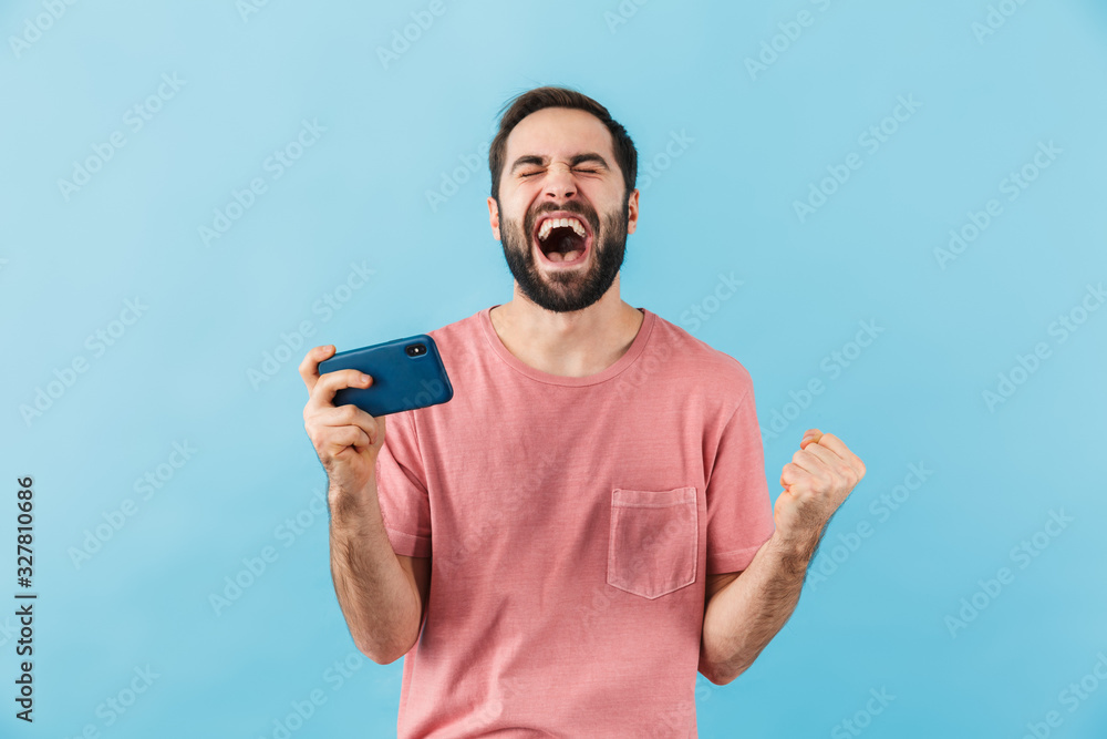 Happy man isolated over blue wall background Happy man isolated over blue wall background