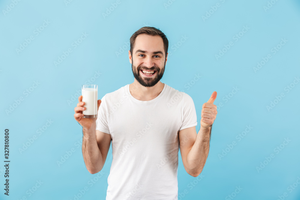 Positive pleased man holding milk. Positive pleased man holding milk.