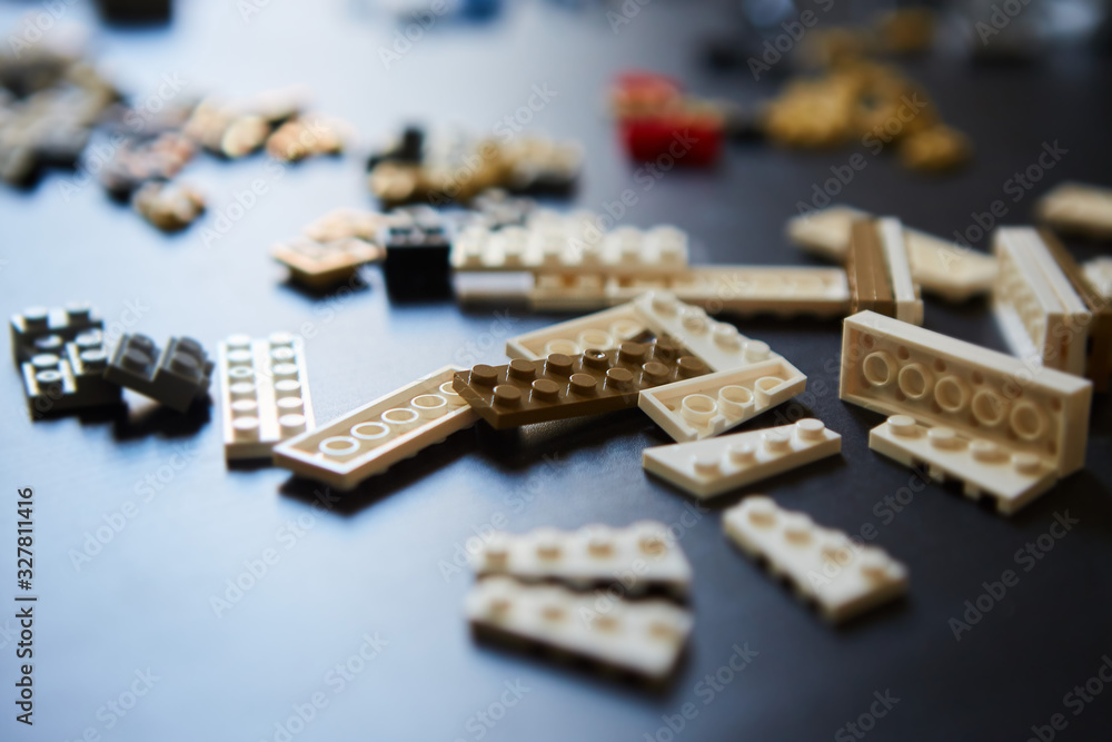 Details of the brick children's constructor are scattered on the table. Details of the brick children's constructor are scattered on the table.
