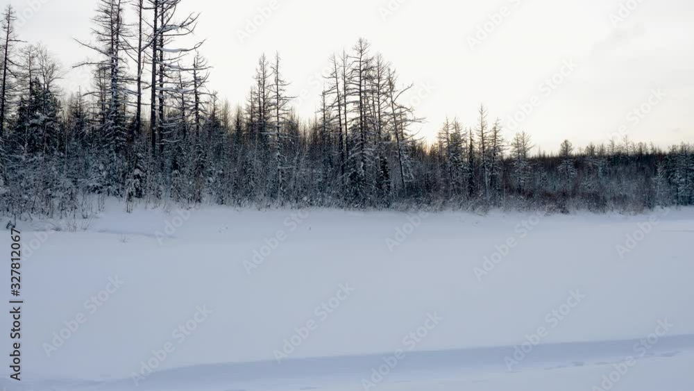 Winter landscape. Panoramic view of snowy road along the frozen Yenisei river surrounded by forest covered with snow. Nature of Siberia. Russia. 4K Winter landscape. Panoramic view of snowy road along the frozen Yenisei river surrounded by forest covered with snow. Nature of Siberia. Russia. 4K