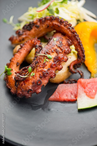Octopus. Fresh caught octopus, seasoned with salt & pepper & grilled w/ olive oil and lemon juice. Served w/ a green leaf salad, heirloom tomatoes, red onions and Kalamata olives.