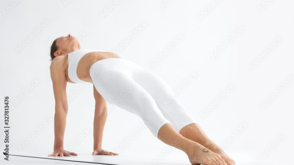 Senior woman in white space practice yoga camera zoom in. Clear white space and woman practice yoga Senior woman in white space practice yoga camera zoom in. Clear white space and woman practice yoga