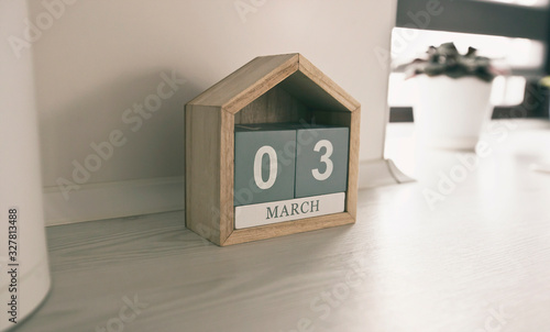 The calendar made from wooden blocks on the table in the kitchen